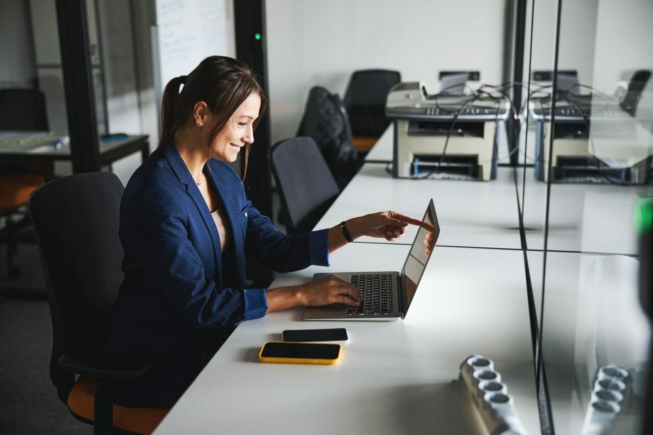 About us 1 beautiful elegant web designer working at the laptop while using internet in the workspace